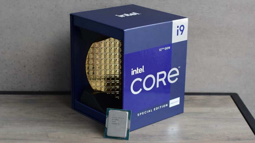 An Intel Core i9-12900KS CPU propped up against its packaging, on a small table.
