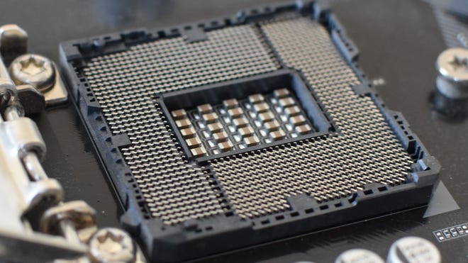 A close up of the pins in an Intel LGA motherboard socket.