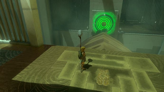 Link near a glowing, green panel which has lit up after metal balls were rolled towards it in the Iun-orok Shrine.