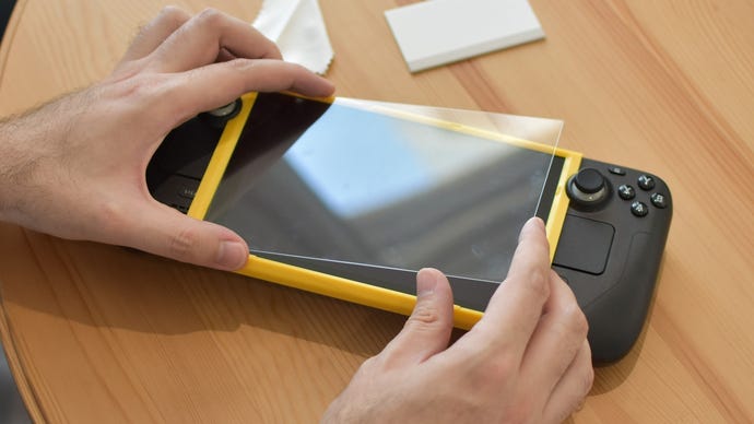 Applying a JSAUX Steam Deck screen protector with the bundled alligning tool.