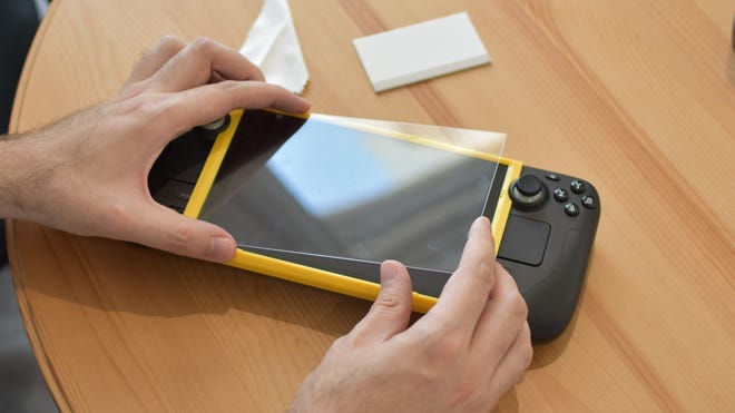 The JSAUX Tempered Glass Screen Protector being applied to a Steam Deck.