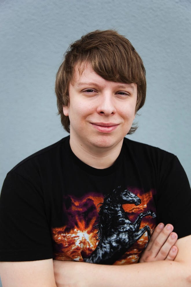 Headshot of Kerry Shawcross smiling with his arms crossed