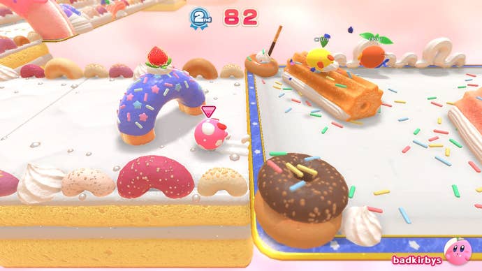 Three different coloured Kirby's race on a donut-themed course in Kirby's Dream Buffet