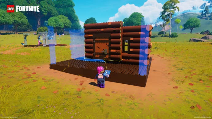 A screenshot from Lego Fortnite showing a log cabin being built, wall by wall.