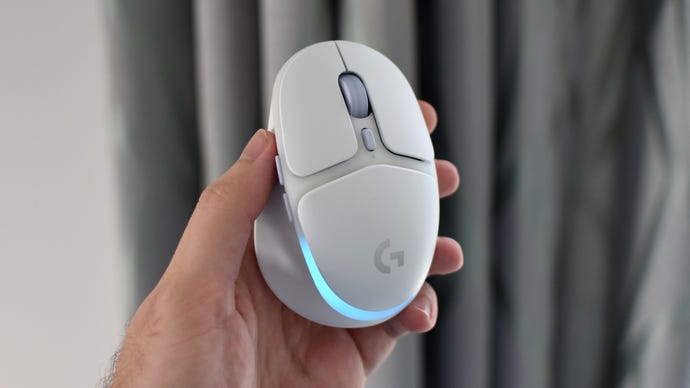 The Logitech G705 gaming mouse behing held up in a hand.