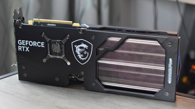 The MSI GeForce RTX 4060 Ti on a table with its black metal backplate facing the camera.
