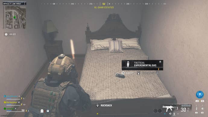 The player picks up some Experimental Gas from a bed in a building in MW3 Zombies