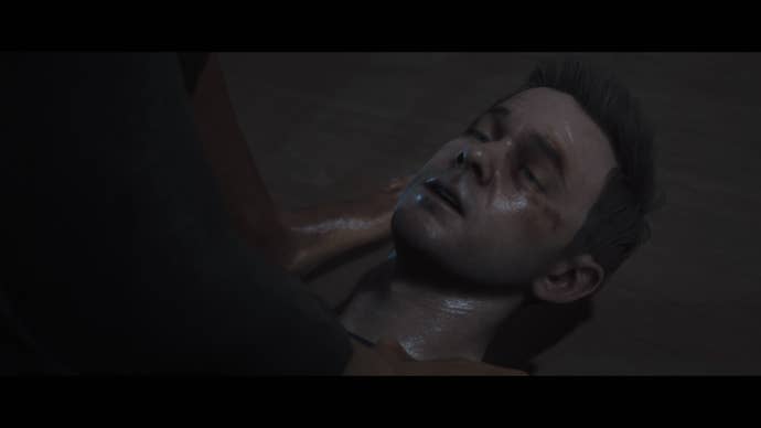 Conrad lies on the floor injured, with a black eye, in Man of Medan.