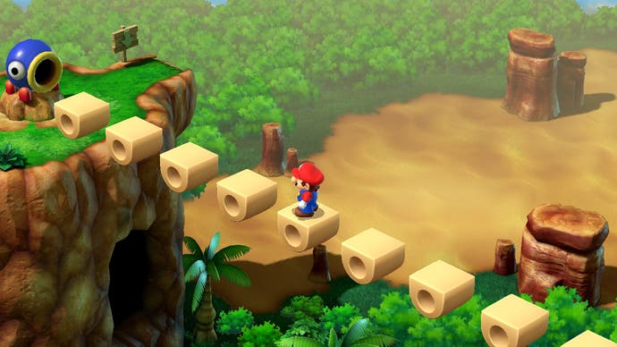 Mario crosses a bridge above a bit of a drop in this screen from Super Mario RPG. A canon awaits him at the far end.