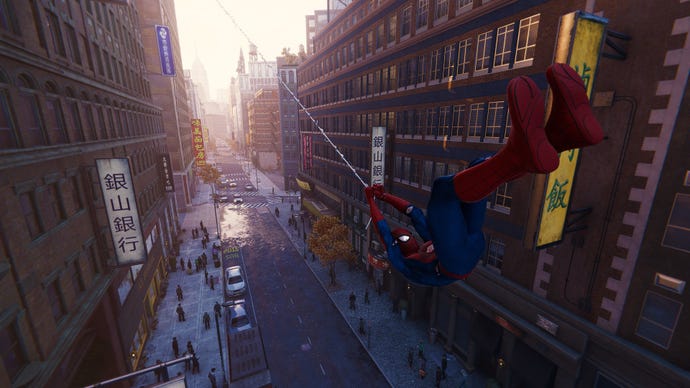 Spider-Man swings down a Manhattan street in Marvel's Spider-Man Remastered.