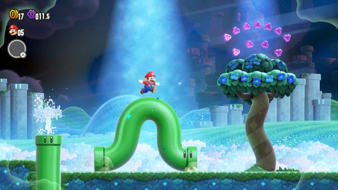 A screenshot from Super Mario Bros. Wonder showing Mario on a wriggling green pipe.