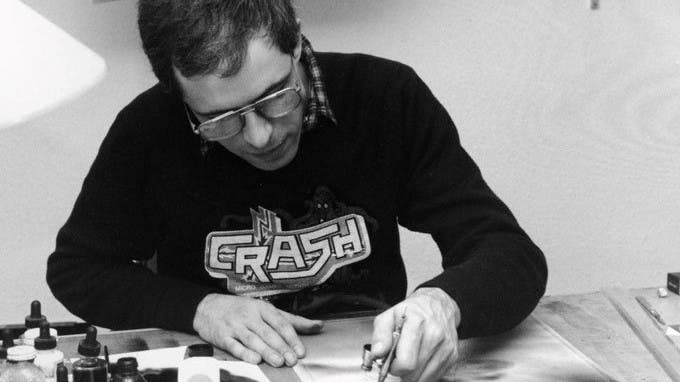 Artist Oli Frey at work, in a black and white picture, wearing a Crash magazine t-shirt.
