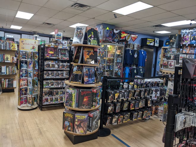 Interior image of Midtown Comics featuring comics and tshirts and toys for sale