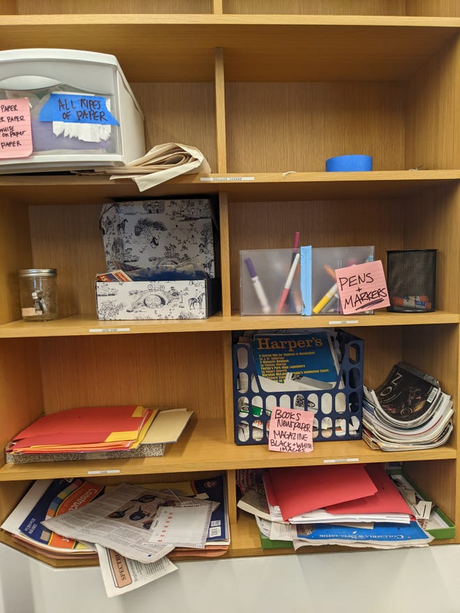 A photograph of eight shelves with zine making materials such as markers, pens, and magazines