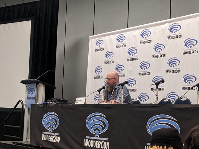 Photograph of Jason Aaron sitting at a Wondercon panel table talking into a microphone
