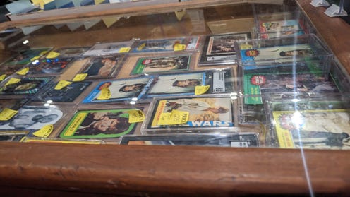 Photograph of glass cases filled with Star Wars collectable cards