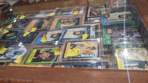 Photograph of glass cases filled with Star Wars collectable cards
