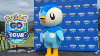 Photograph of Piplup in front of step and repeat