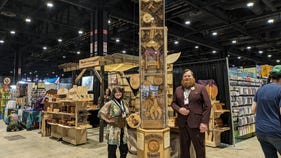 Photograph of James Farmer and Kayla next to dice tower