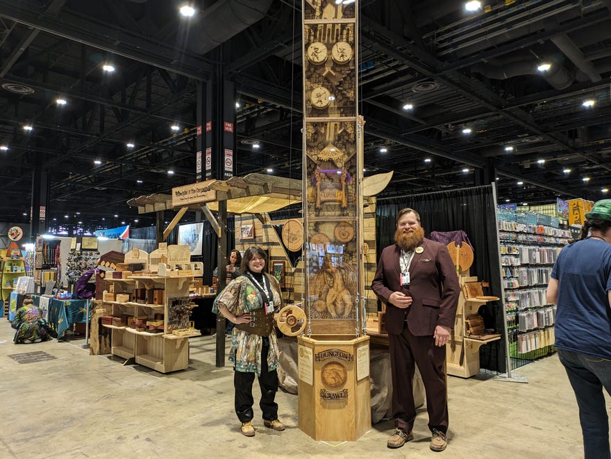 Photograph of James Farmer and Kayla next to dice tower