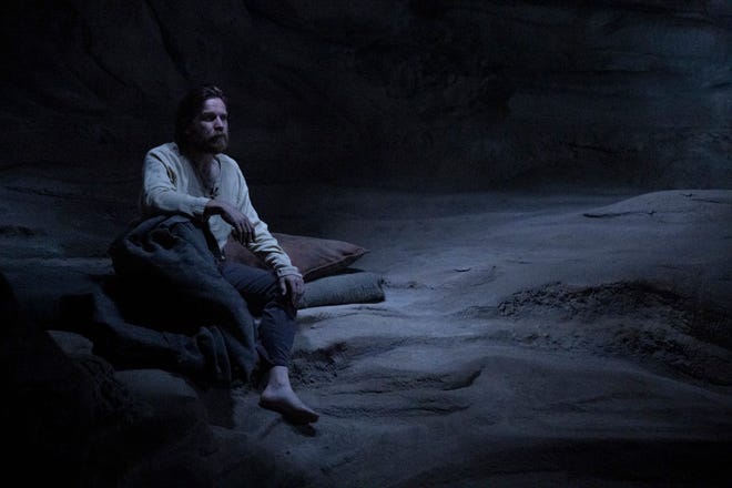 Image of Ewan Mcgregor as Obi Wan Kenobi sitting in a cave