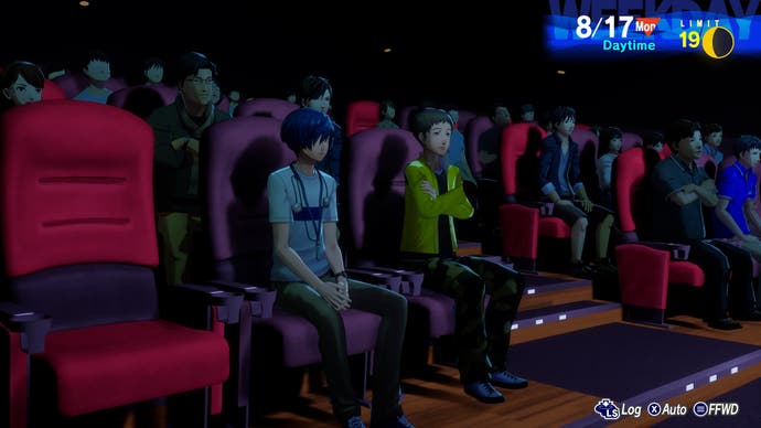 رهبر و یک دوست در یک سینمای شلوغ در یک اسکرین شات از Persona 3 Reload نشسته اند.