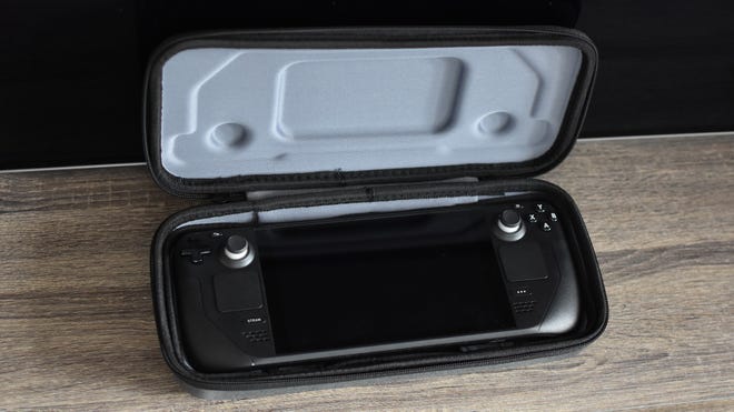 A Steam Deck inside a hard carry case, which is propped open.