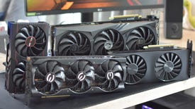 Several different graphics cards arranged on a desk.