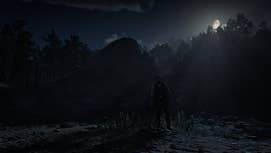 Arthur Morgan stands outside of the cave where the Feral Man (also known as a wereman or werewolf) can be found in Red Dead Redemption 2