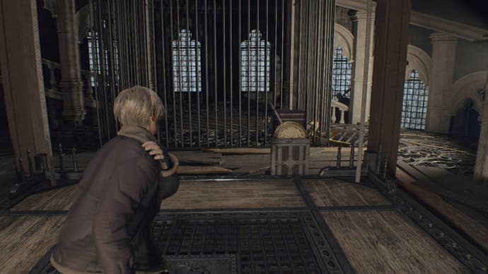 Leon stands atop a wooden lift with a lever on it in Resident Evil 4 Remake