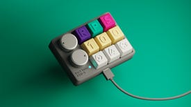 A macro keypad with RPS 100 keys on a green background