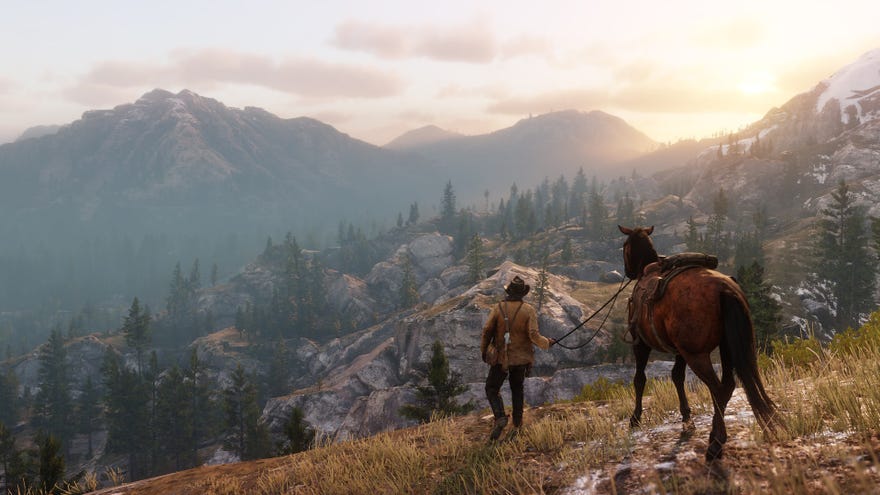 An image of Arthur Morgan holding the reins of a horse from behind. They are staring out over the craggy woodland mountains of Red Dead Redemption 2 beneath the orange-tinted sky.