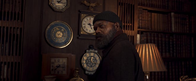 Still image of Nick Fury in a beanie looking over his shoulder