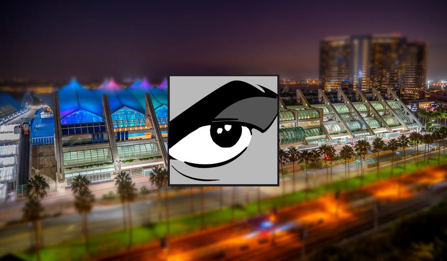 Nighttime photo of San Diego Convention center with the San Diego Comic Con logo over it
