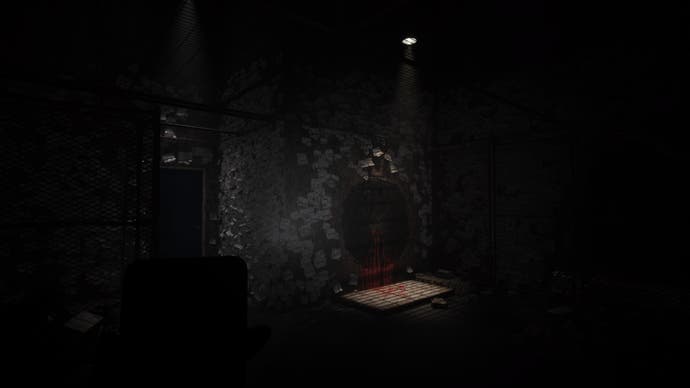 Silent Hill The Short Message Screenshot. A spotlight in a filthy, sticky-note-covered room highlights a crudely drawn hole, not dissimilar to the hole in Henry's apartment in Silent Hill 4.