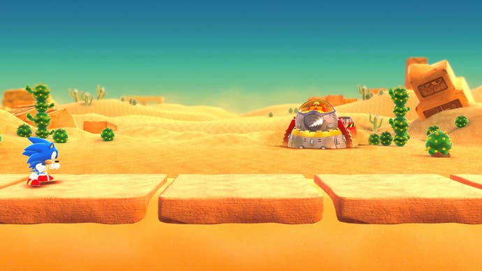 Sonic en un nivel desértico con un robot Eggman a lo lejos