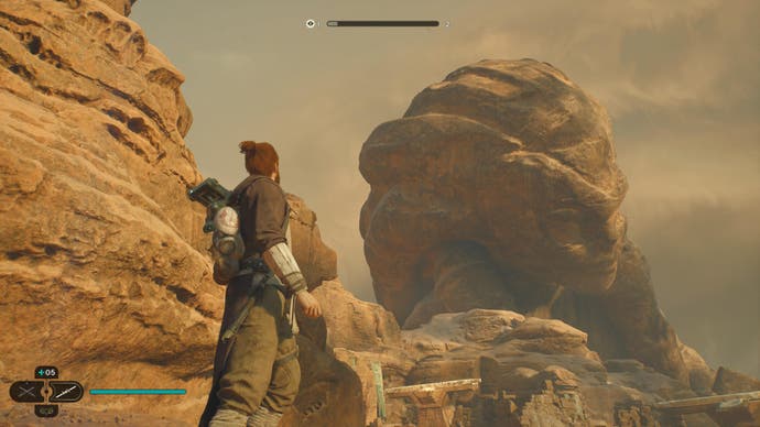Star Wars Jedi Survivor review - screenshot showing Cal and BD-1 looking at a sprawling statue on Jedha
