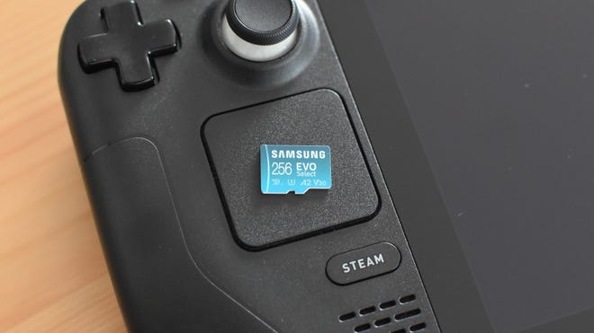 A Samsung Evo Select microSD card sitting on top of a Steam Deck.