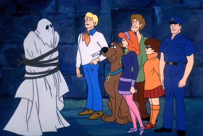 Scooby-Doo and the gang about to unmask a ghost