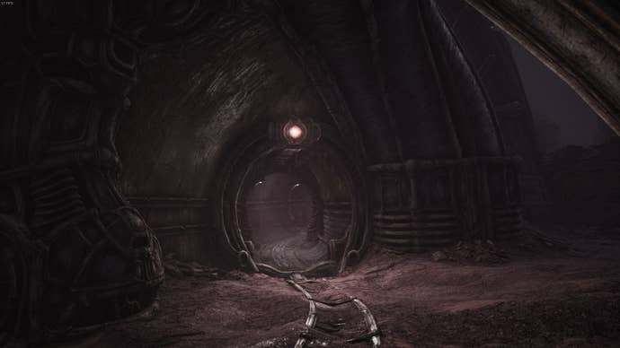 The player faces the entrance to a building in Act 2 of Scorn