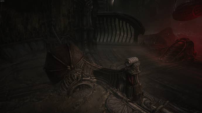The player looks at a machine, made up of a shell-like item and metal item, in Act 2 of Scorn
