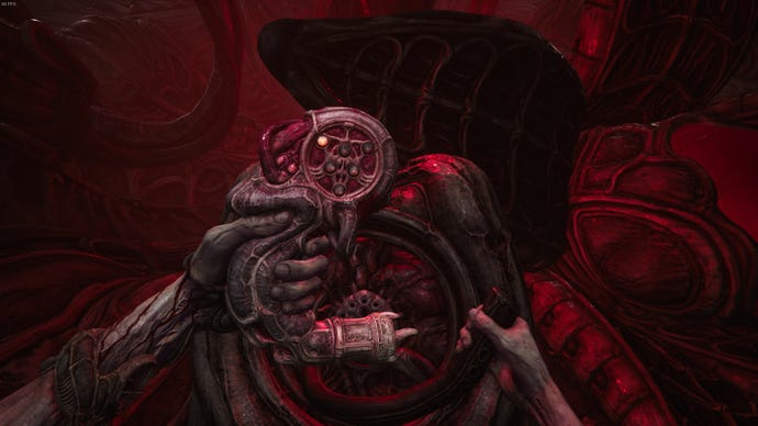 The player holds a door-opening tool in Act 2 of Scorn