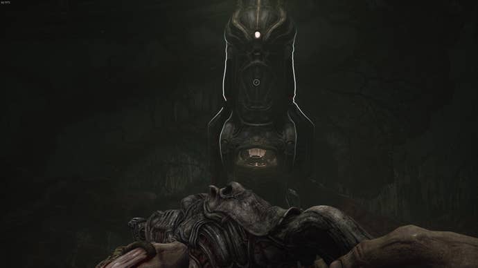 The player faces a machine that restores their healing item in Act 3 of Scorn