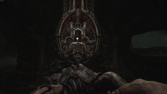 The player faces a machine that upgrades their healing item in Act 3 of Scorn