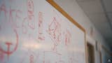 A busy whiteboard with a blurry "AKE 6" apparent in the foreground.