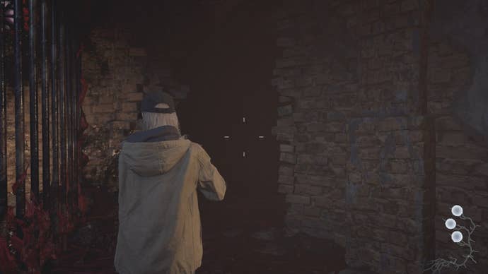 Rose Winters looks toward a broken wall in Resident Evil Village's Shadows of Rose DLC