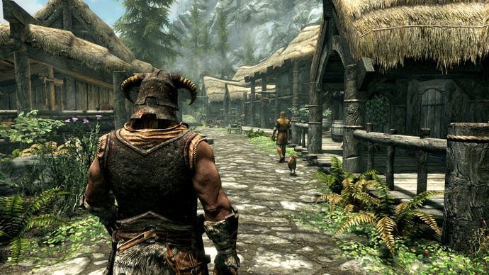 Third person view of the hero from Skyrim walking through the town of Riverwood