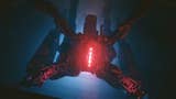 a robot resembling a spider looking down with a red glow in its centre