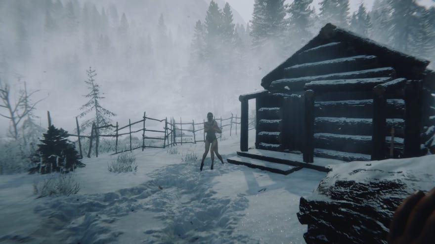 Игрок, держащий бревно, приближается к Вирджинии, когда она дрожит в снегу в сыновьях леса