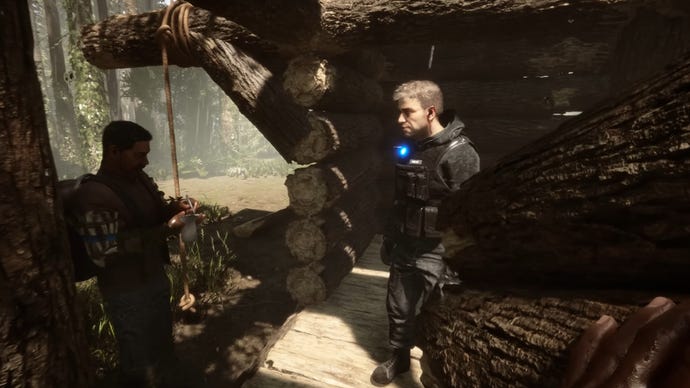 森の中で2人のプレイヤーが日陰のある小屋に立っていたことを示す森のイメージの息子たち。